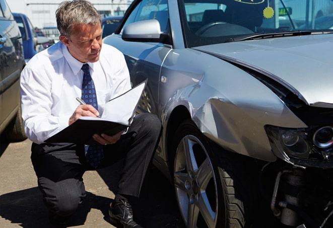 auto insurance policy document and pen